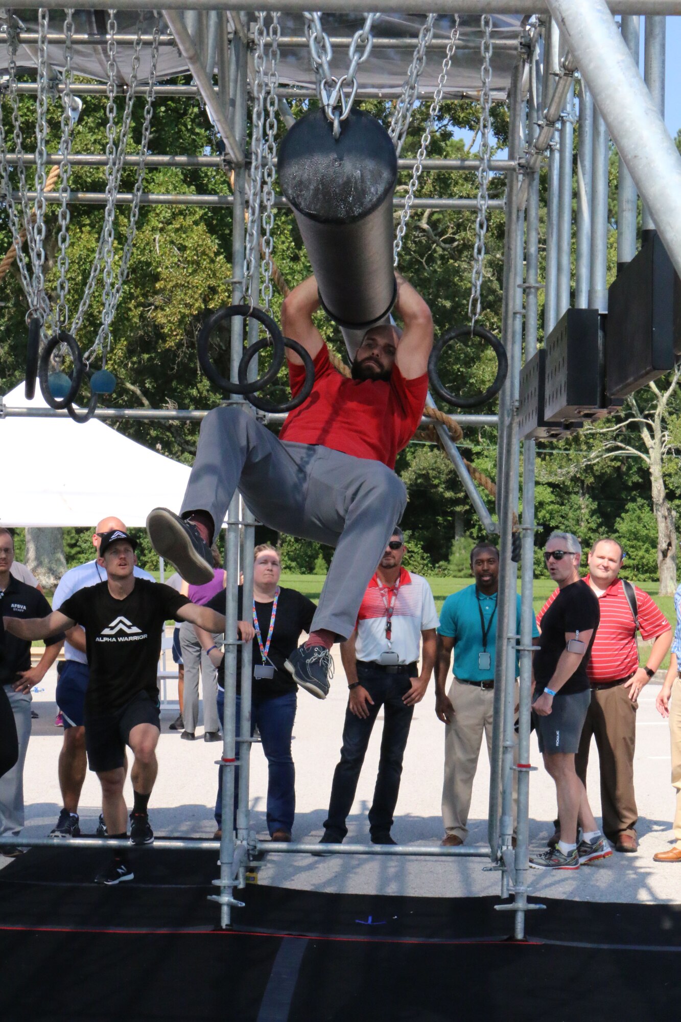 Paul Ritter attempts to clear the “Battering Ram” portion of the Alpha Warrior Battle Rig while the crowd looks on. (U.S. Air Force photo by Brad Hicks) (This image was manipulated by obscuring badges for security purposes)