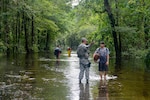 A U.S. Air Force Security Forces Airman assigned to the South Carolina Air National Guard, 169th Fighter Wing, from McEntire Joint National Guard Base, working alongside Florence County, S.C., Sheriff’s Department, assists civilians during evacuation efforts as the Black Creek River begins to crest in Florence, S.C., Sept. 17, 2018. Approximately 3,400 Soldiers and Airmen have been mobilized to respond and participate in recovery efforts as Tropical Storm Florence has caused flooding and damage to the state.