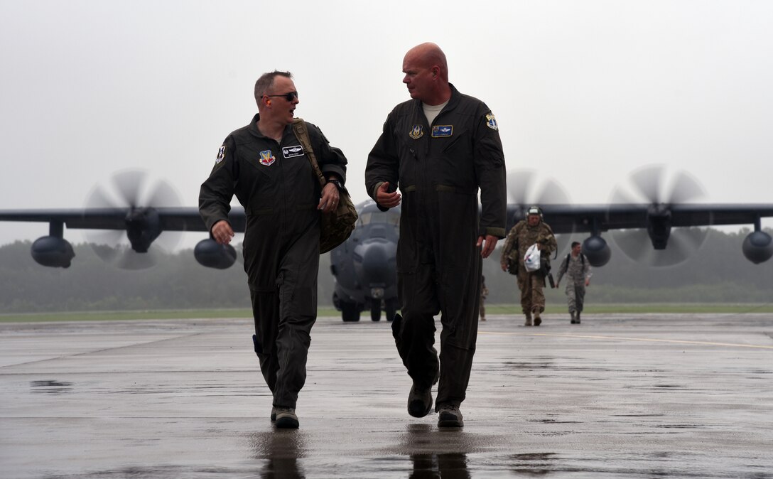 Col. Bryan Creel, 334th Air Expeditionary Group commander, discusses search-and-rescue operational plans with Lt. Col. Jeff Hannold, 334th AEG deputy commander, at Joint Base Charleston on Sept. 15, 2018. Airmen and equipment from the 334th AEG arrived aboard HC-130J Combat King II aircraft and HH-60G Pave Hawks from Moody Air Force Base. The 344th AEG are being pre-positioned to be ready to provide relief in the wake of tropical storm Florence. The 334th AEG is an expeditionary search and rescue unit comprised of 23d Wing and 920th Rescue Wing personnel and assets ready to perform surface, fixed wing and rotary SAR operations when needed. (U.S. Air Force Photo by Technical Sgt. Kelly Goonan)