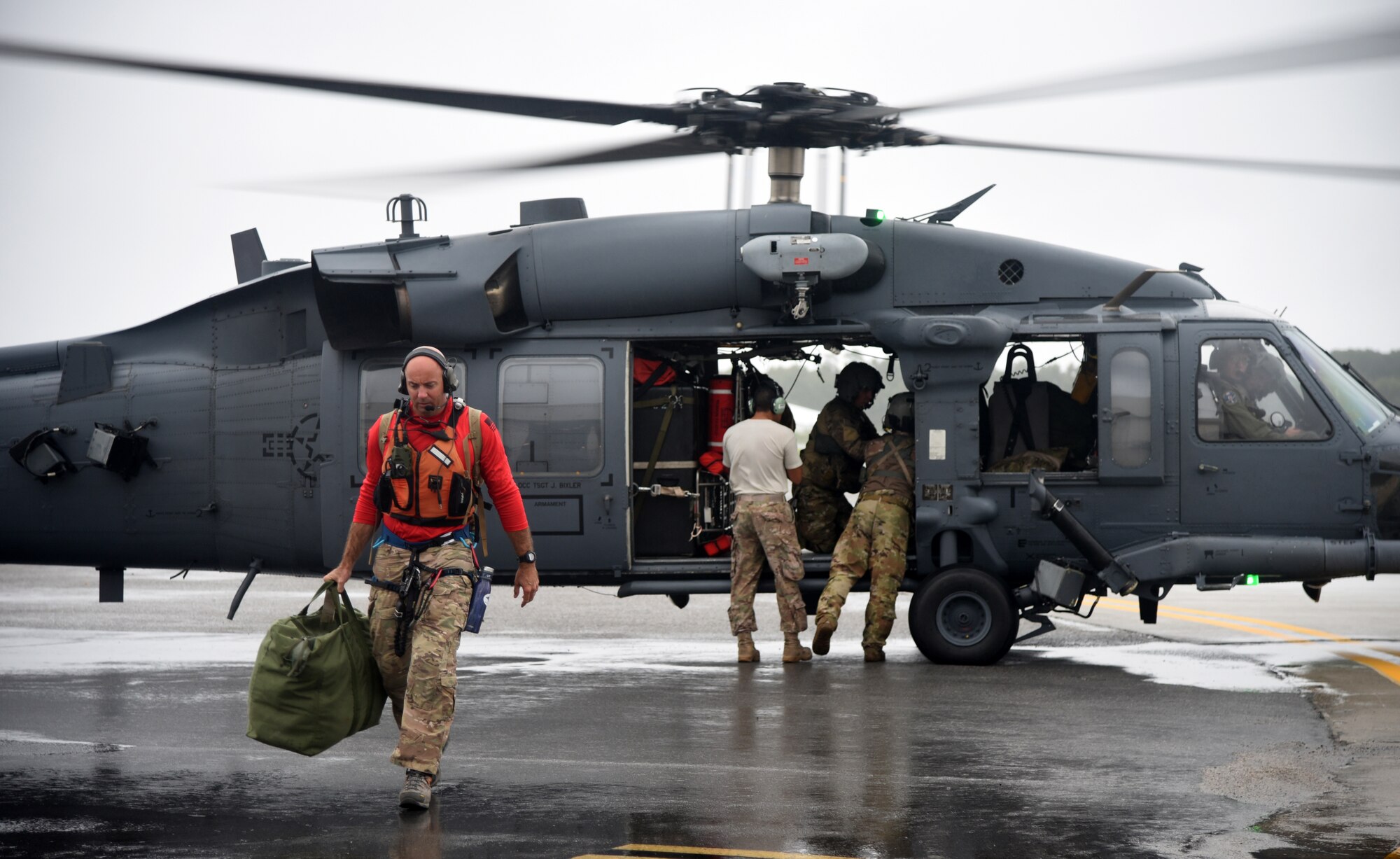 Senior Master Sgt. Wes Hufnagel, a pararescueman, departs on an HH-60 Pave Hawk helicopter at Joint Base Charleston, S.C., Sept. 15, 2018. Airmen and equipment from the 334th Air Expeditionary Group arrived at Joint Base Charleston, S.C. aboard HC-130J Combat King II aircraft and HH-60G Pave Hawks from Moody Air Force Base, Georgia. The 344th AEG is being pre-positioned to be ready to provide search-and-rescue relief in the wake of Hurricane Florence. The 334th AEG is an expeditionary search-and-rescue unit comprised of 23d Wing (Moody AFB, Ga.) and 920th Rescue Wing (Patrick AFB, Florid) personnel and assets ready to perform surface, fixed- wing and rotary SAR operations when needed. (U.S. Air Force Photo by Technical Sgt. Kelly Goonan)