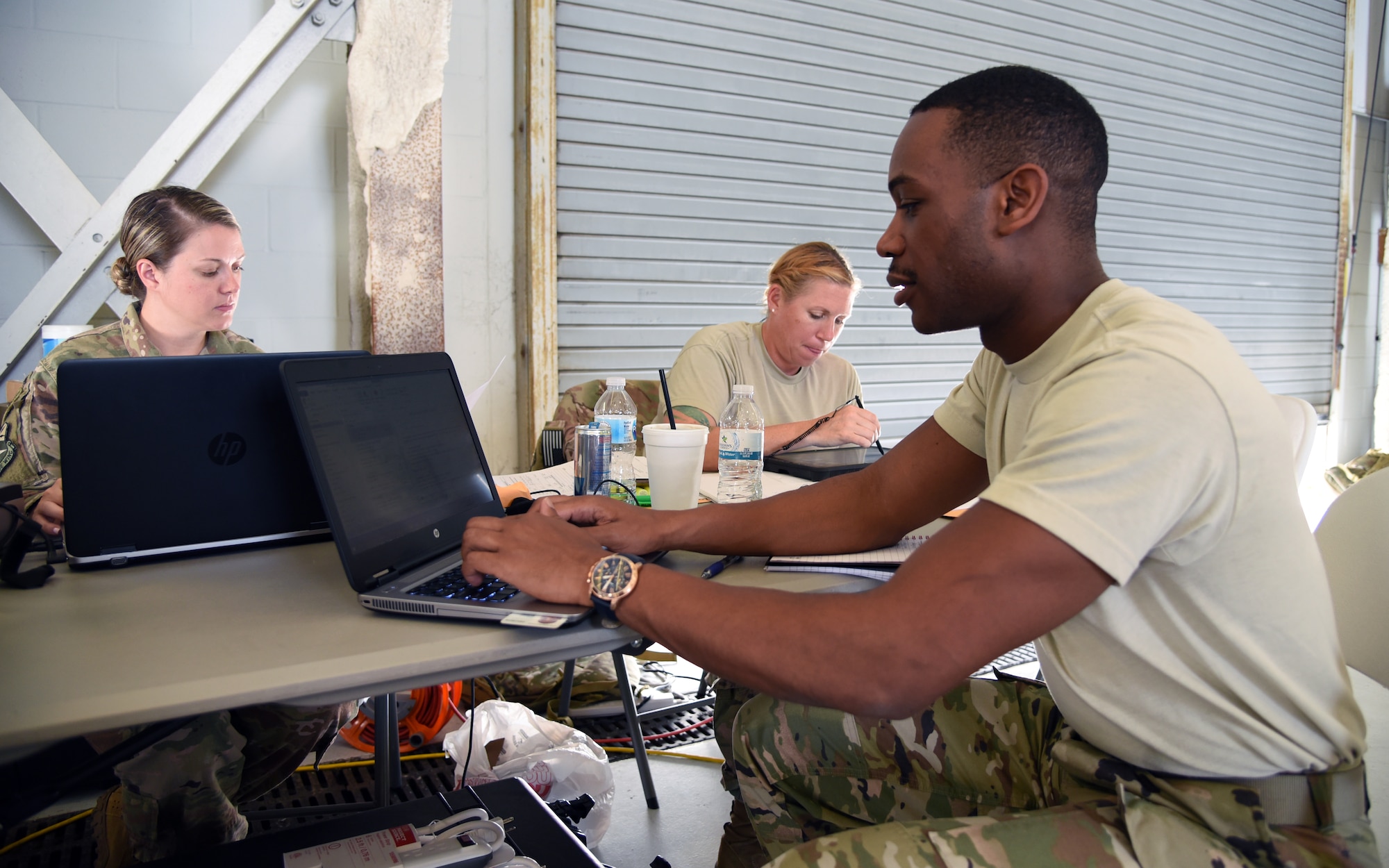 Tech. Sgt. Damon Jones (Jacksonville, Florida), SrA. Alexandra Dubois (Melbourne, Florida) and Master Sgt. Michelle St. Laurent (Melbourne, Florida) track flight times and personnel documents for the 334th Air Expeditionary Group inside the staging hangar at Joint Base Charleston, S.C., Sept. 16, 2018 in support of Hurricane Florence Relief Operations. All three Airmen are forward deployed from the 920th Rescue Wing, at Patrick Air Force Base, Florida. (U.S. Air Force photo/Tech. Sgt. Kelly Goonan)