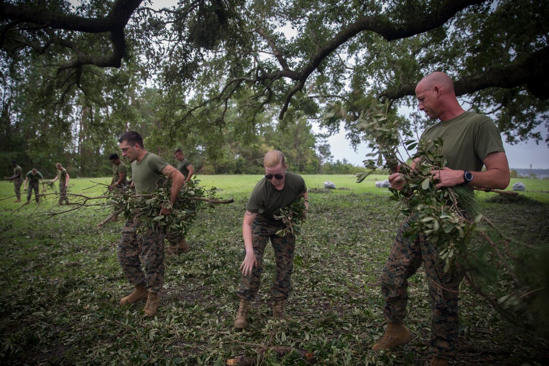 U.S. Marines Corps Sgt. Maj. Steven L. Lunsford, right, sergeant major of 2nd Marine Logistics Group (2nd MLG), assists clean up efforts at Camp Lejeune, N.C., Sept. 17, 2018. Recovery and repair efforts began on base Saturday, September 15, with the majority of efforts focused on clearing roadways and restoring power to critical areas aboard Camp Lejeune following Hurricane Florence. (U.S. Marine Corps photo by Sgt. Bethanie C. Sahms)