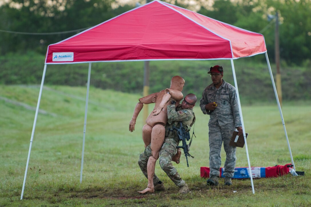 Tech. Sgt. Matthew Heiser, 49th Security Forces Squadron flight sergeant, lifts a simulated victims over his shoulder during the 2018 Defender Challenge, Sept. 12, at Joint Base San Antonio-Camp Bullis, Texas. Teams representing all twelve Air Force major commands, the Royal Air Force Regiment and German Air Force participated in the friendly competition, which tested their capabilities in dismounted operations, combat endurance and weapons tactics. The Air Combat Command team won second place in the overall competition, combat endurance and weapons challenge. (U.S. Air Force photo by Airman Taryn Butler)