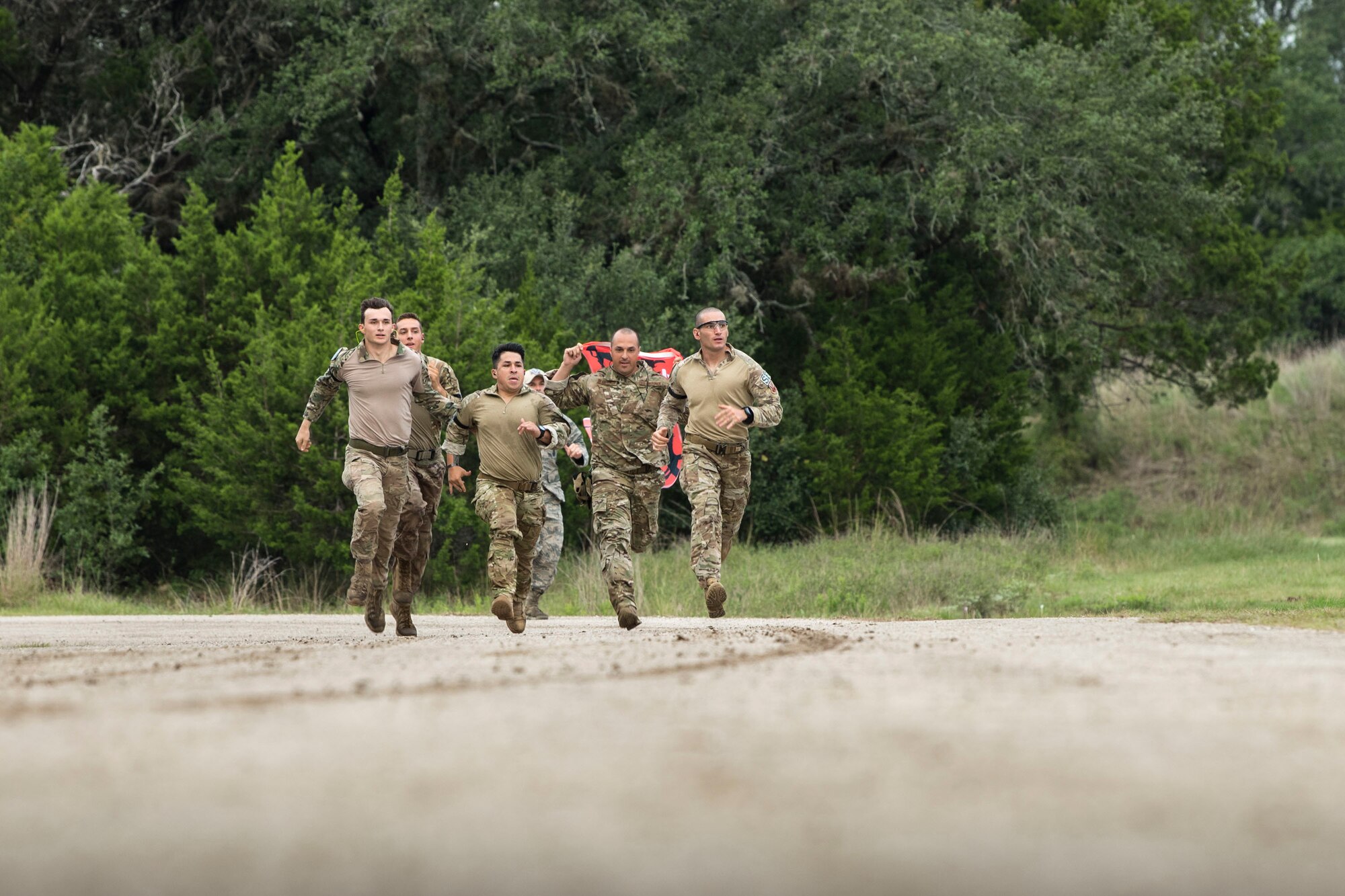 Airmen from Air Combat Command (ACC) sprint to the starting point of a relay during the 2018 Defender Challenge, Sept. 13, at Joint Base San Antonio-Camp Bullis, Texas. Teams representing all twelve Air Force major commands, the Royal Air Force Regiment and German Air Force participated in the friendly competition, which tested their capabilities in dismounted operations, combat endurance and weapons tactics. The ACC team won second place in the overall competition, combat endurance and weapons challenge. (U.S. Air Force photo by Airman Taryn Butler)
