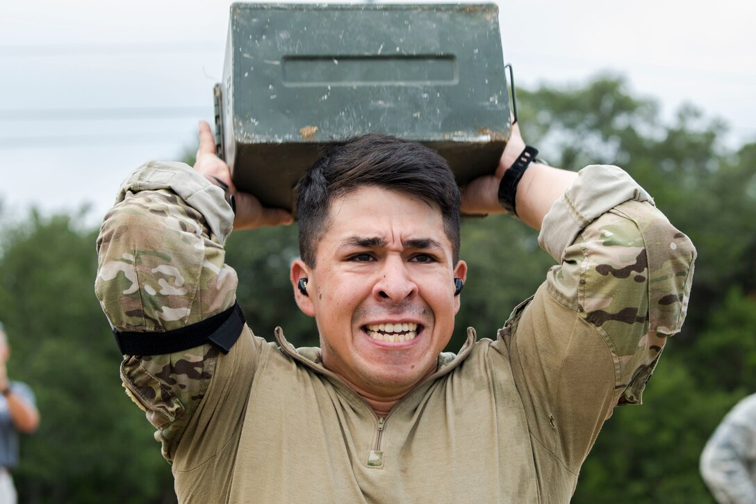Staff Sgt. Paul Rosales, 55th Security Forces Squadron combat arms instructor, heaves an ammo container during the 2018 Defender Challenge, Sept. 13, at Joint Base San Antonio-Camp Bullis, Texas. Teams representing all twelve Air Force major commands, the Royal Air Force Regiment and German Air Force participated in the friendly competition, which tested their capabilities in dismounted operations, combat endurance and weapons tactics. The ACC team won second place in the overall competition, combat endurance and weapons challenge. (U.S. Air Force photo by Airman Taryn Butler)