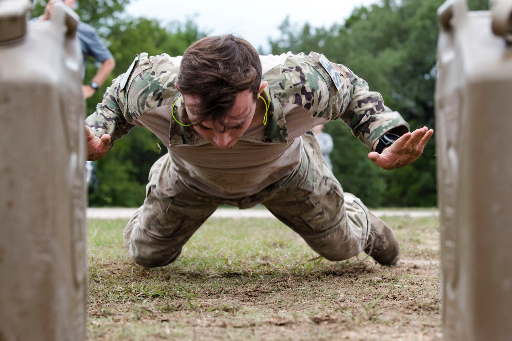 Senior Airman Jeffrey Lewis, 822d Base Defense Squadron fireteam lead, performs burpees during the 2018 Defender Challenge, Sept. 13, at Joint Base San Antonio-Camp Bullis, Texas. Teams representing all twelve Air Force major commands, the Royal Air Force Regiment and German Air Force participated in the friendly competition, which tested their capabilities in dismounted operations, combat endurance and weapons tactics. The ACC team won second place in the overall competition, combat endurance and weapons challenge. (U.S. Air Force photo by Airman Taryn Butler)
