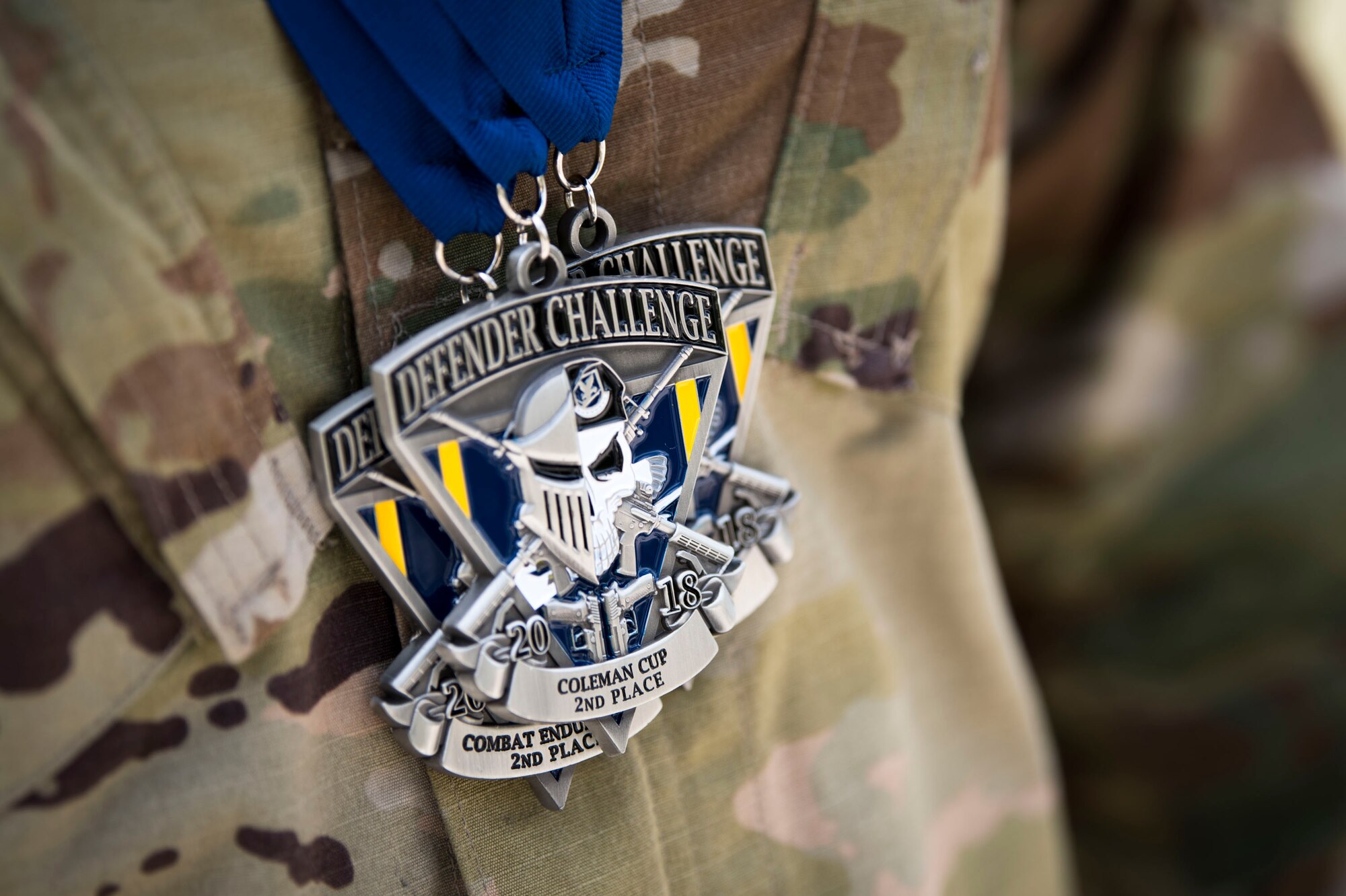 Medals rest on an Airman from Air Combat Command (ACC) during the 2018 Defender Challenge, Sept. 13, at Joint Base San Antonio-Camp Bullis, Texas. Teams representing all twelve Air Force major commands, the Royal Air Force Regiment and German Air Force participated in the friendly competition, which tested their capabilities in dismounted operations, combat endurance and weapons tactics. The ACC team won second place in the overall competition, combat endurance and weapons challenge. (U.S. Air Force photo by Airman Taryn Butler)