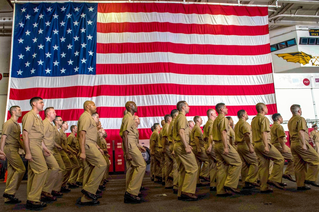 Sailors sing in formation.