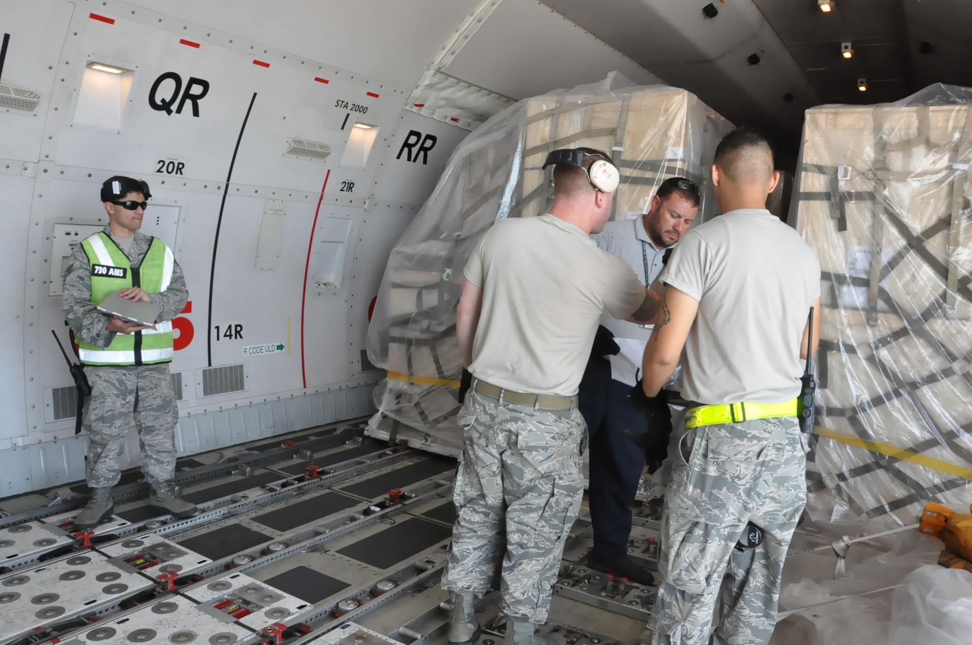 Airmen from the 730th Air Mobility Squadron offload cargo at Yokota Air Base, Japan before the aircraft continues onto Paya Lebar Air Base in Singapore, 22 Aug. 2018. Air Mobility Command sustains 42 en-route locations around the globe through the use of a complex system of channel routes. These routes enable transport of personnel and worldwide cargo from location to location to sustain the joint warfighter.