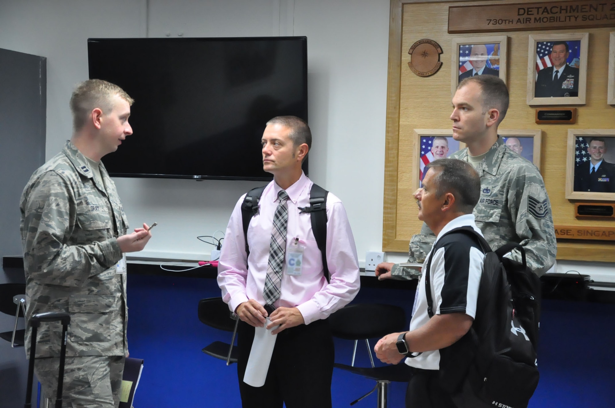 Capt. Chris Gray explains the capabilities of the 730th Air Mobility Squadron Detachment 2 at Paya Lebar Air Base, Singapore to Global Channel Operations Directorate (XOG) commercial and offshore cargo bookies from the 618th Air Operations Center, Scott AFB, Ill 24 Aug. 2018. XOG maintains XX channel routes, similar to the Pacific channel route which begins at Travis Air Force Base, California. Personnel and cargo are then transported to Elmendorf AFB, Alaska; Yokota Air Base, Japan; Paya Lebar AB, Singapore; and end at Navy Support Facility, Diego Garcia.