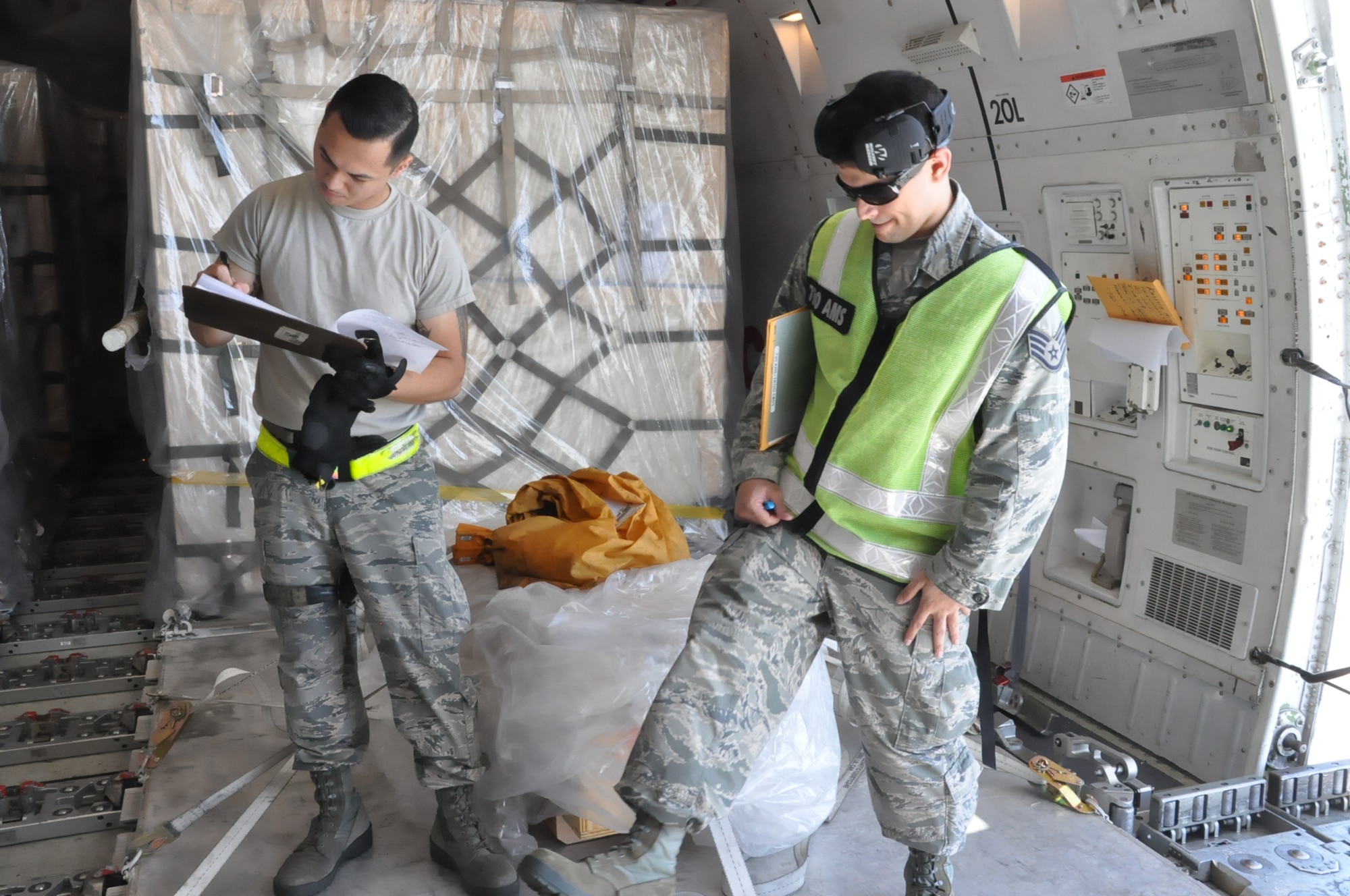 Tech. Sgt. David Lauritzen and Staff Sgt. Abner Lopez, 730th Air Mobility Squadron special handling professionals, inspect and sign for registered mail at Yokota Air Base, Japan, 22 Aug. 2018. Air Mobility Command sustains 42 en-route locations around the globe through the use of a complex system of channels. These channels enable transport of personnel and worldwide cargo from location to location to sustain the joint warfighter.