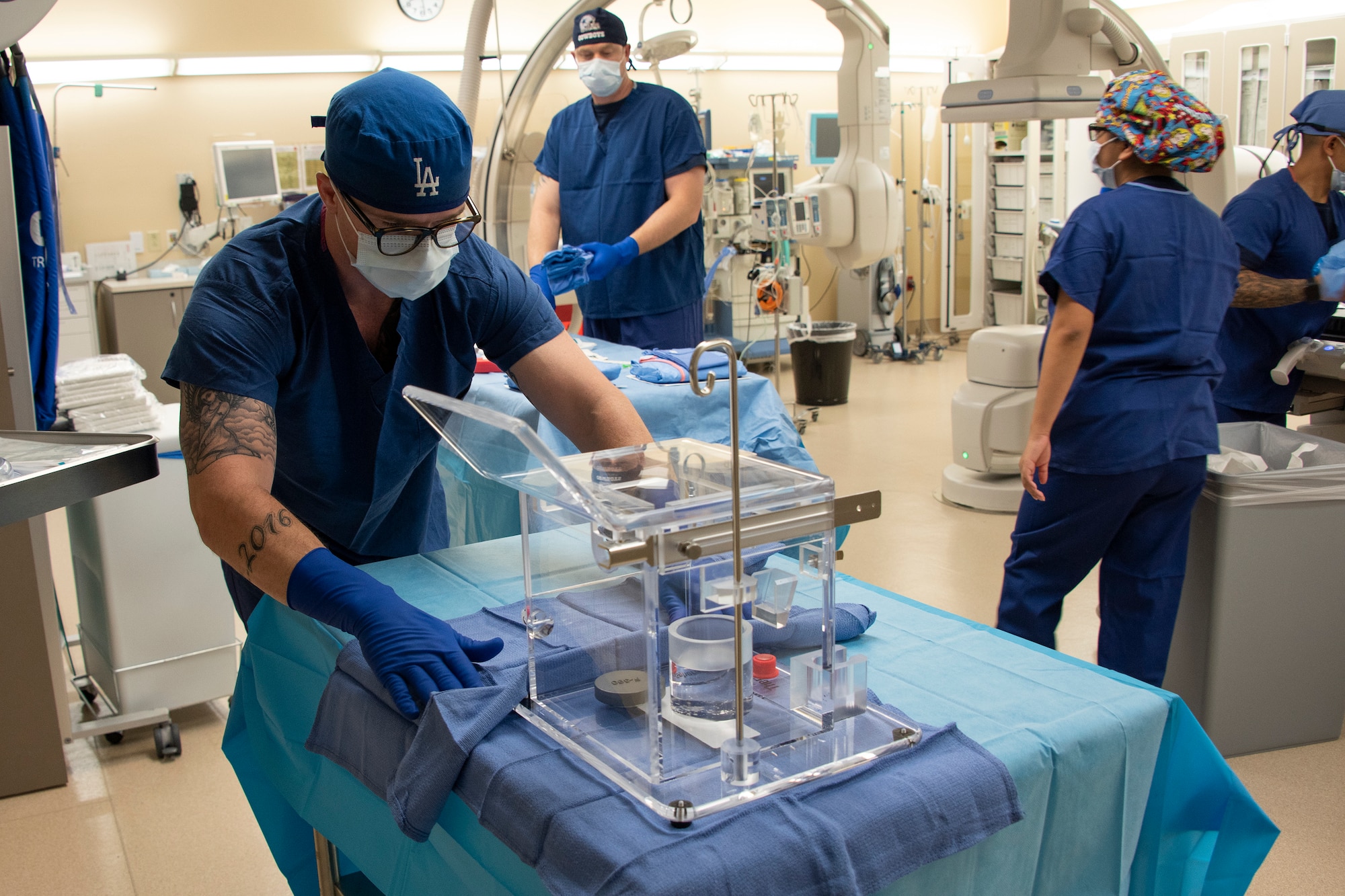 U.S. Air Force Senior Airman Justin Ritzel, 60th Diagnostics and Therapeutics Squadron, prepares a tray of specialized medical equipment ahead of an Yttrium-90 radioembolization procedure for a patient with liver cancer Sept. 7, 2018, atTravis Air Force Base, Calif. The Y-90 radioembolization is an advanced and minimally invasive method utilized to treat cancer by delivering millions of tiny radioactive beads inside the blood vessels that feed a tumor. The high dose of targeted radiation prospectively kills the tumor while sparing normal tissue. This was the first time the treatment was performed at David Grant USAF Medical Center. (U.S. Air Force photo by Heide Couch)
