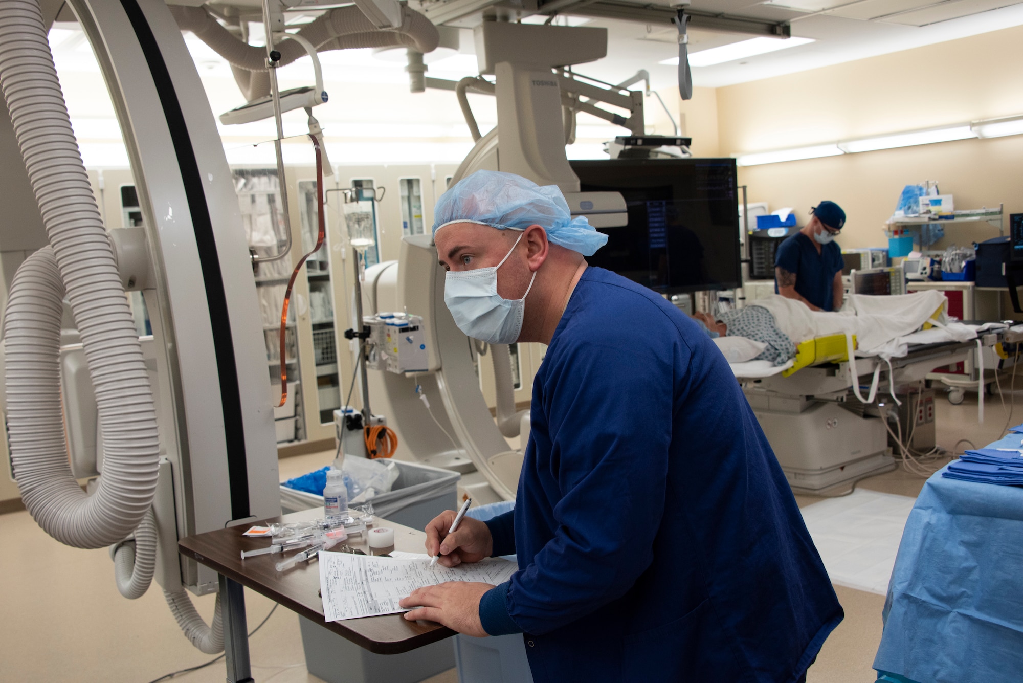 U.S. Air Force Capt. Brandon Valenzuela, 60th Inpatient Squadron, conducts pre-operation measures during an Yttrium-90 radioembolization procedure for a patient with liver cancer Sept. 7, 2018, at Travis Air Force Base, Calif. The Y-90 radioembolization is an advanced and minimally invasive method utilized to treat cancer by delivering millions of tiny radioactive beads inside the blood vessels that feed a tumor. The high dose of targeted radiation prospectively kills the tumor while sparing normal tissue. This was the first time the treatment was performed at David Grant USAF Medical Center. (U.S. Air Force Photo by Heide Couch)