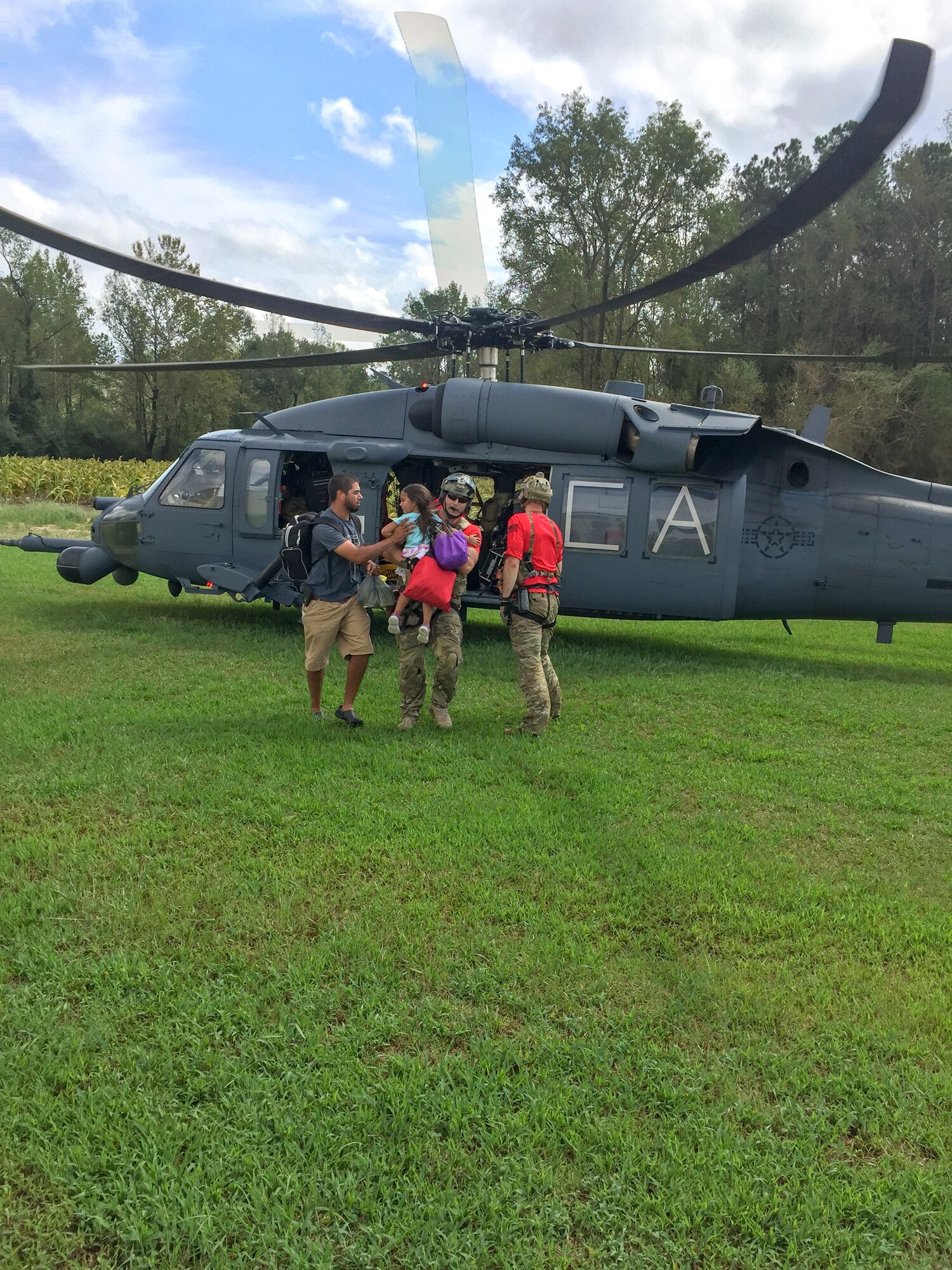 Alaska Air National Guardsmen from the 176th Wing’s 212th Rescue Squadron assist with recovering isolated flood survivors via a California ANG’s HH-60 Pavehawk helicopter crewed by members of the 210th RQS near Sampson County, N.C., Sept. 17, 2018. (Courtesy photo)