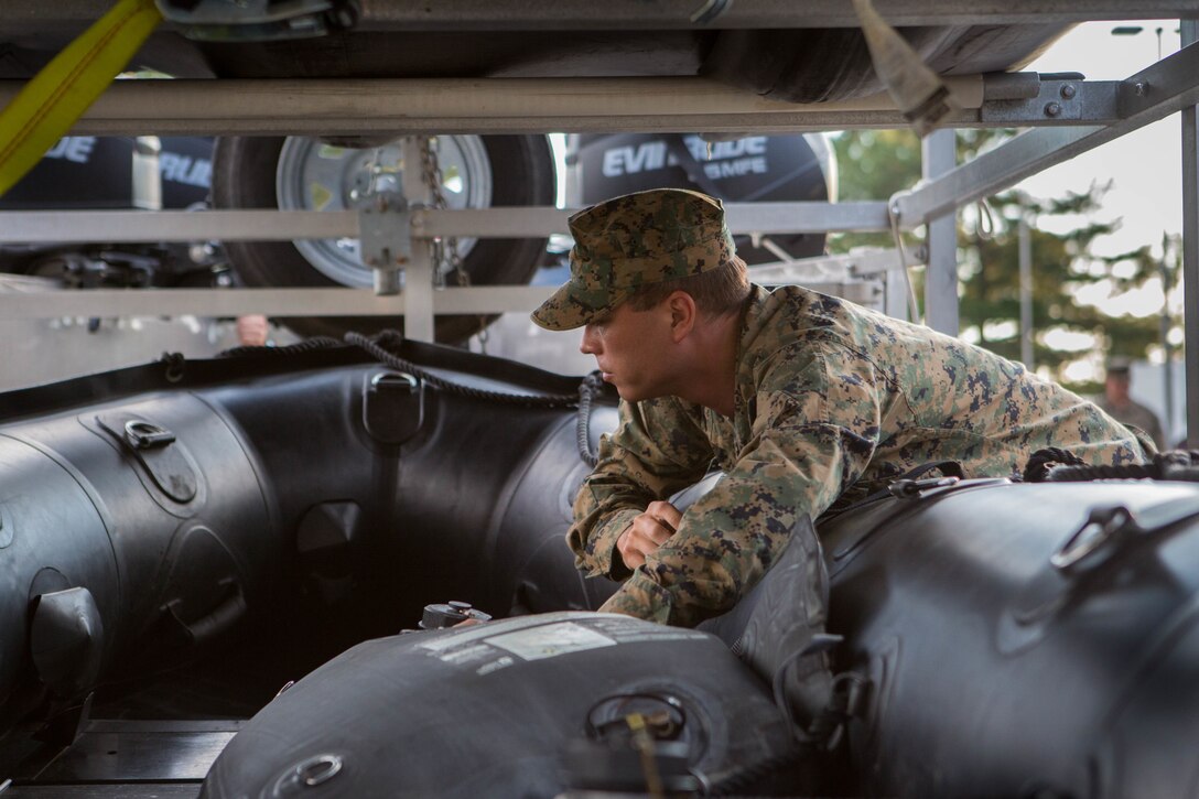 Sgt. Steven M. Holmes, a Small Craft Mechanic with 3rd Force Reconnaissance Company, 4th Marine Division, inspects a F470 Combat Rubber Raiding Craft at McCrady Training Center, South Carolina, Sept. 17, 2018. Marine Forces Reserve has a great deal of expertise in the area of response and recovery, gained from Humanitarian Assistance/Disaster Relief across the globe and is part of a coordinated response poised to provide Department of Defense

support to FEMA, state and local response efforts during Hurricane Florence. (U.S. Marine Corps photo by Cpl. Andy O. Martinez)