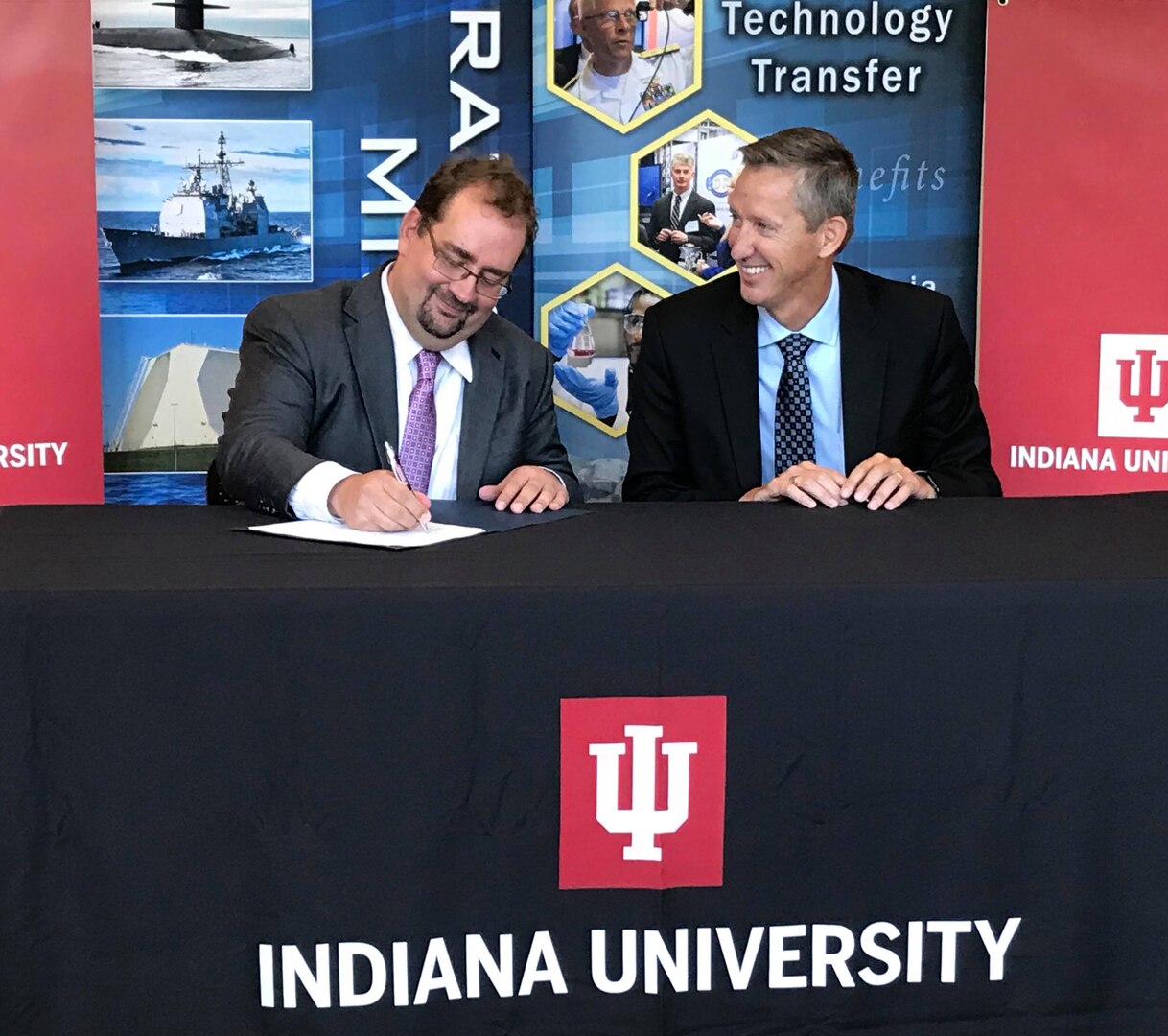Indiana University's CACR Director Mr. Von Welch and NSWC Crane Technical Director Dr. Brett Seidle re-signed a CRADA agreement on Sept. 13, 2018. The goal is to grow the collaboration between IU and NSWC Crane to improve capabilities in the areas of software assurance and trusted artificial intelligence.