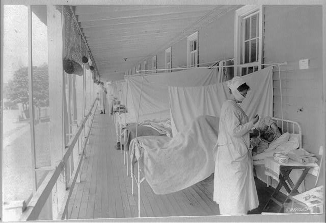 A nurse checks a patient's pulse during a pandemic flu outbreak in 1918.
