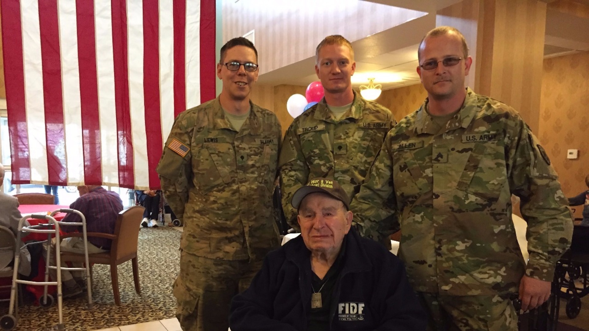 ​Spc. Brice Lewis(L), Spc. Camron Troup and Sgt. Elihu Allen(R) of E company 2-135 General Support Aviation Battalion, Colorado Army National Guard, welcome home U.S. Army CPL (R) Sid Shafner, 94, Saturday May 14, 2016, at the Brookdale Mountain View Senior Living Center in Denver. Shafner is one of three concentration camp liberators flown to Europe by the Friends of the Israel Defense Forces for a 10-day trip to be reunited with holocaust survivors rescued by their units during WWII. (Photo by Robin Wilson/Released)