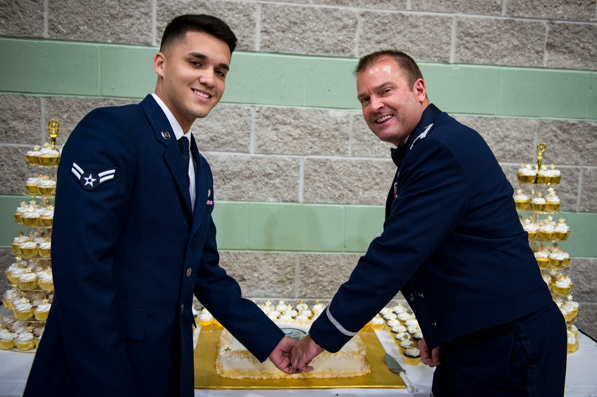 Airman 1st Class David Davenport, left, 23d Logistics Readiness Squadron A-10 parts store apprentice, and Col. Brian Stumpe, 23d Mission Support Group commander, pose for a photo while performing the ceremonial cake-cutting to commemorate the Air Force’s 71st Birthday during the Air Force Ball, Sept. 15, 2018, at the James H. Rainwater Conference Center in Valdosta, Ga. Traditionally, the oldest and youngest service members are the first to cut the cake to commemorate all those who serve. (U.S. Air Force photo by Airman 1st Class Erick Requadt)
