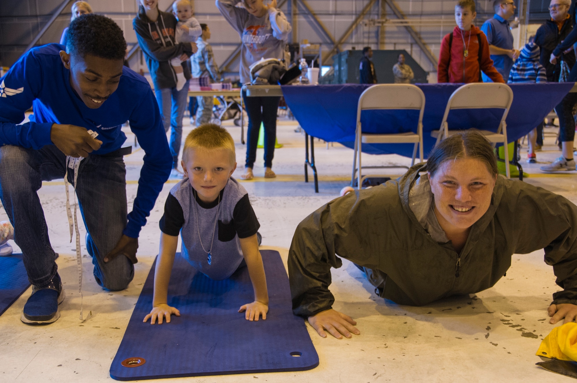 Lamounte Coleman, 434th Development and Training Flight trainee, administers a mock Fit-to-Fight test for children in the mini-deployment line during Family Appreciation Day at Grissom Air Reserve Base, Ind., Sept. 8, 2018. Airmen and their families were invited to have lunch and participate in various activities on base. (U.S. Air Force photo / Senior Airman Harrison Withrow)
