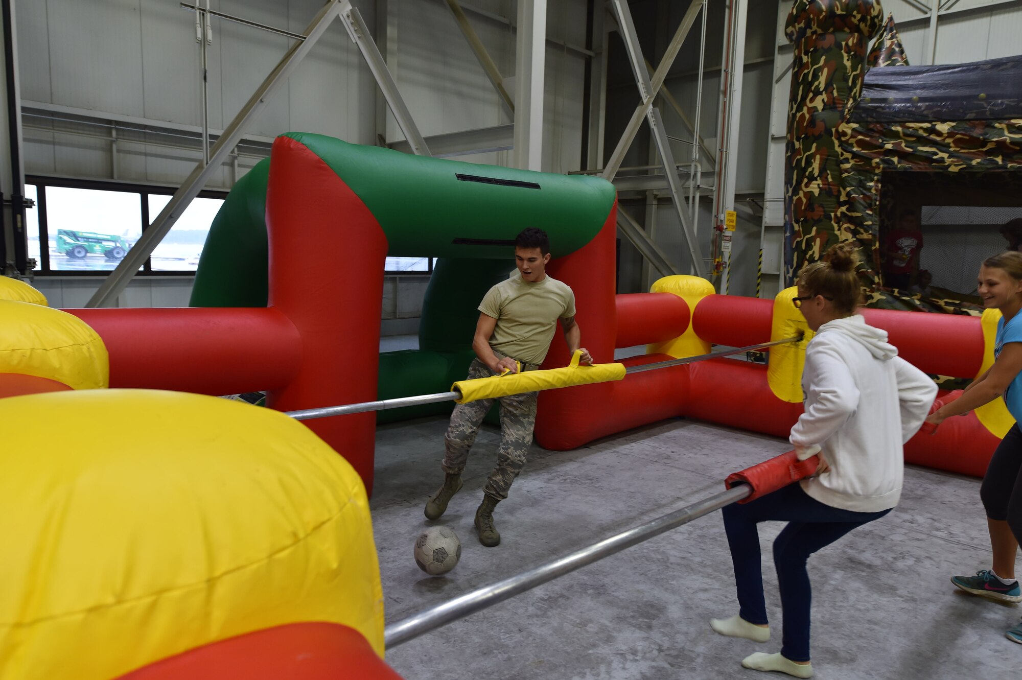 Airman Gabe Mota, 434th Communications Squadron client support technician, blocks a kick during a game of human foosball during Family Appreciation Day at Grissom Air Reserve Base, Ind., Sept. 8, 2018. Airmen and their families were invited to have lunch and participate in various activities on base. (U.S. Air Force photo / Staff Sgt. Jami Lancette)