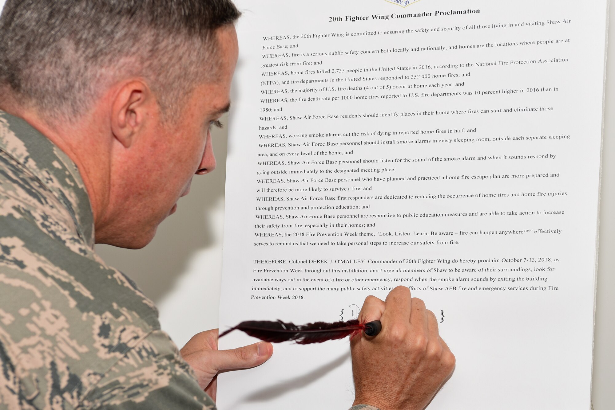 U.S. Air Force Col. Derek O’Malley, 20th Fighter Wing (FW) commander, signs the 20th FW Commander Proclamation, at Shaw Air Force Base, S.C., Sept. 17, 2018.