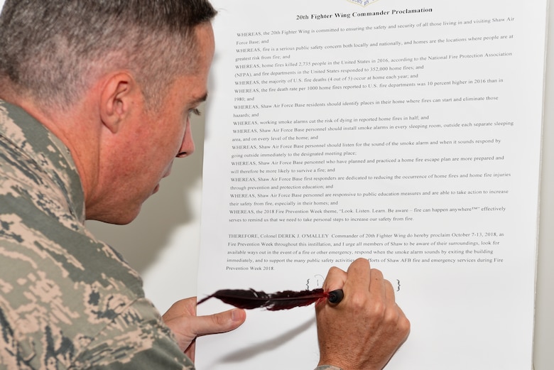 U.S. Air Force Col. Derek O’Malley, 20th Fighter Wing (FW) commander, signs the 20th FW Commander Proclamation, at Shaw Air Force Base, S.C., Sept. 17, 2018.