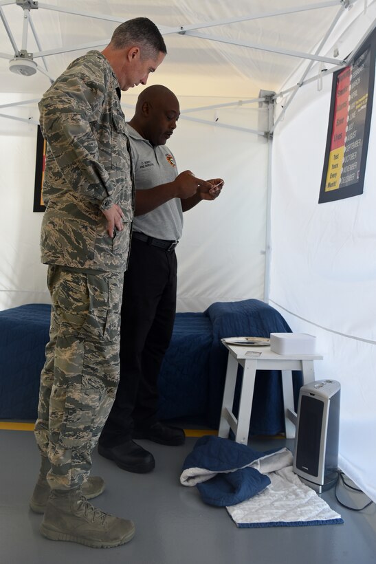 Cornelius Berry, 20th Civil Engineer Squadron fire inspector, right, explains to U.S. Air Force Col. Derek O’Malley, 20th Fighter Wing (FW) commander, “The Great Escape” escape room that will be available during Fire Prevention Week at Shaw Air Force Base, S.C., Sept. 17, 2018.