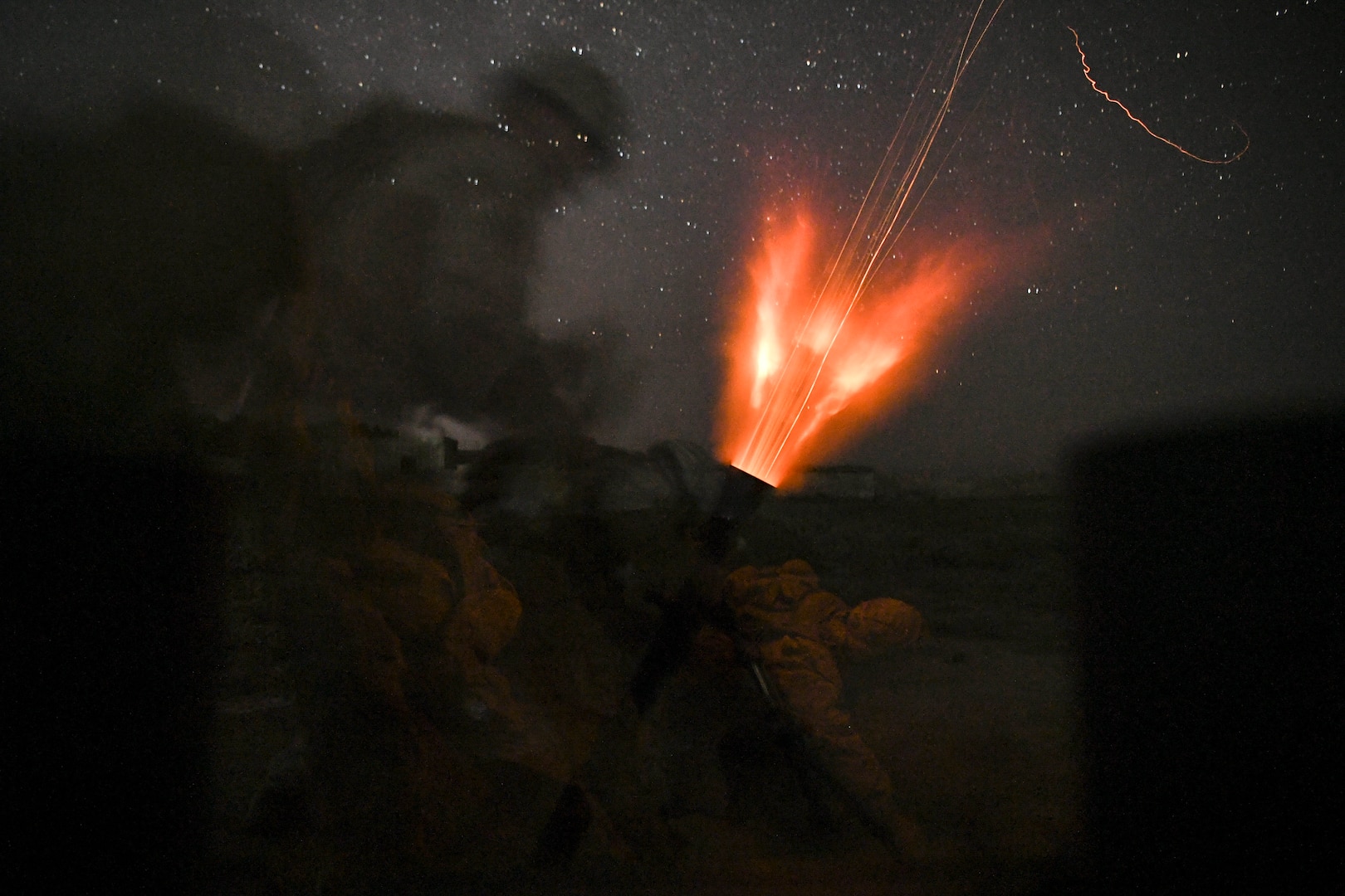 Marines fire mortar.