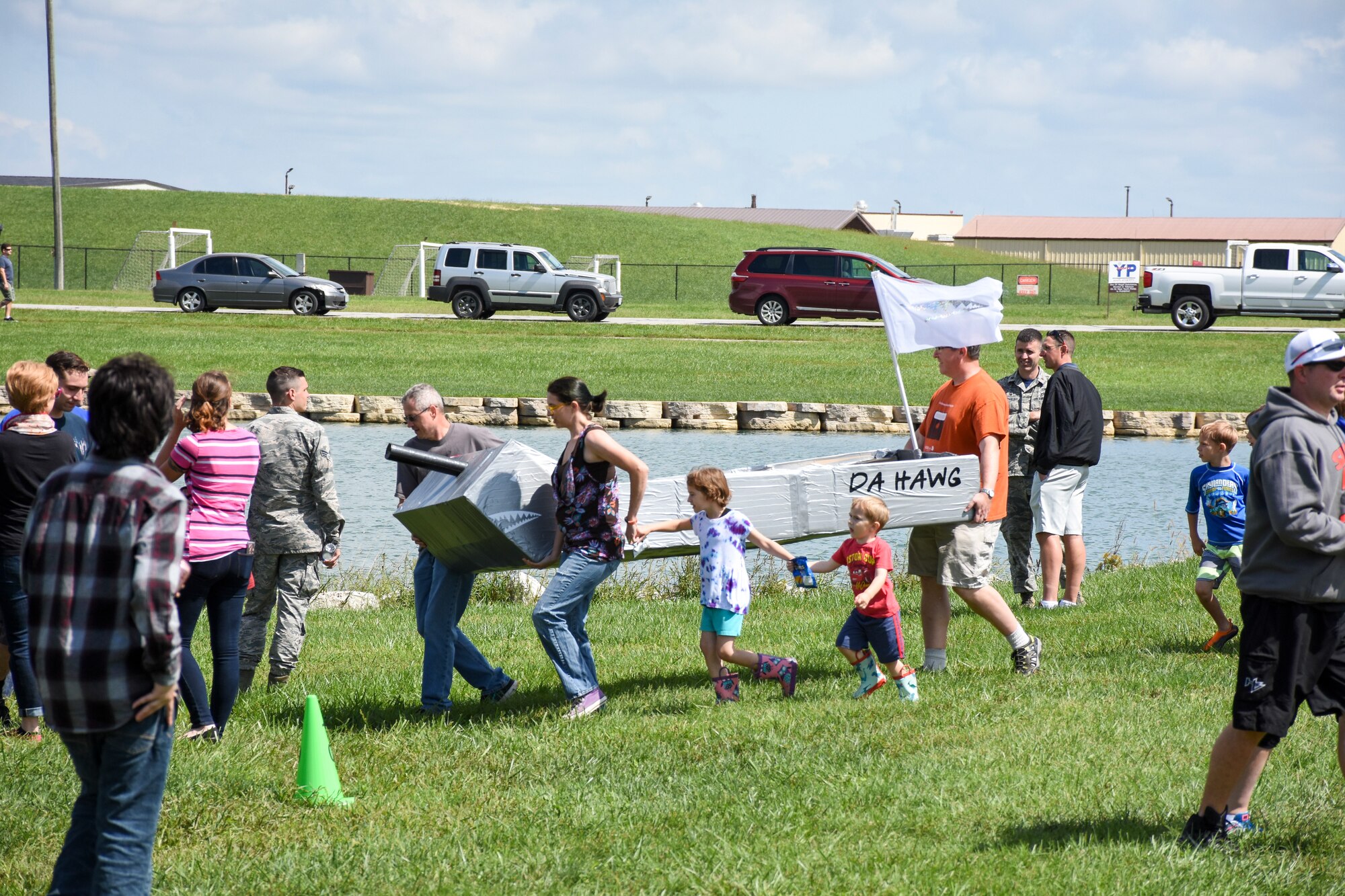 The winning boat from the Carboard Regatta, "Da Hawg," is carried toward the water during the Family Day event Sept. 9, 2018, at Ike Skelton Park on Whiteman Air Force Base, Mo.