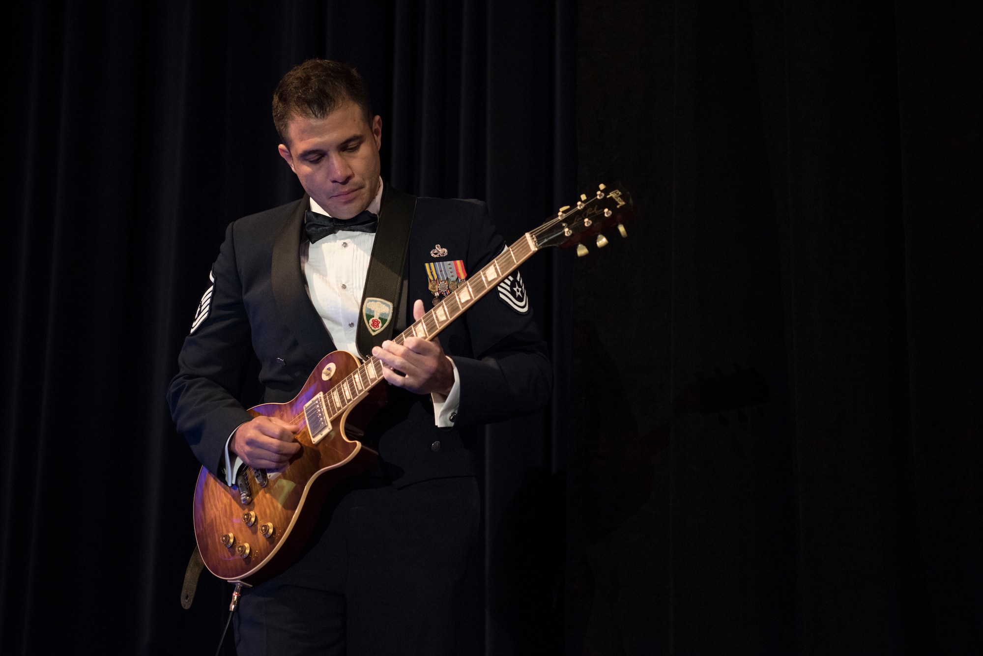 Master Sgt. Philip Albin, 436th Maintenance Squadron nondestructive imaging section chief, plays the national anthem during the Air Force Ball Sept. 15, 2018, in Dover, Del. Throughout the evening, Albin played several segments of iconic songs from the ‘80s, ‘90s and 2000s representing the several generations of Airmen serving at Dover Air Force Base. (U.S. Air Force photo by Staff Sgt. Aaron J. Jenne)
