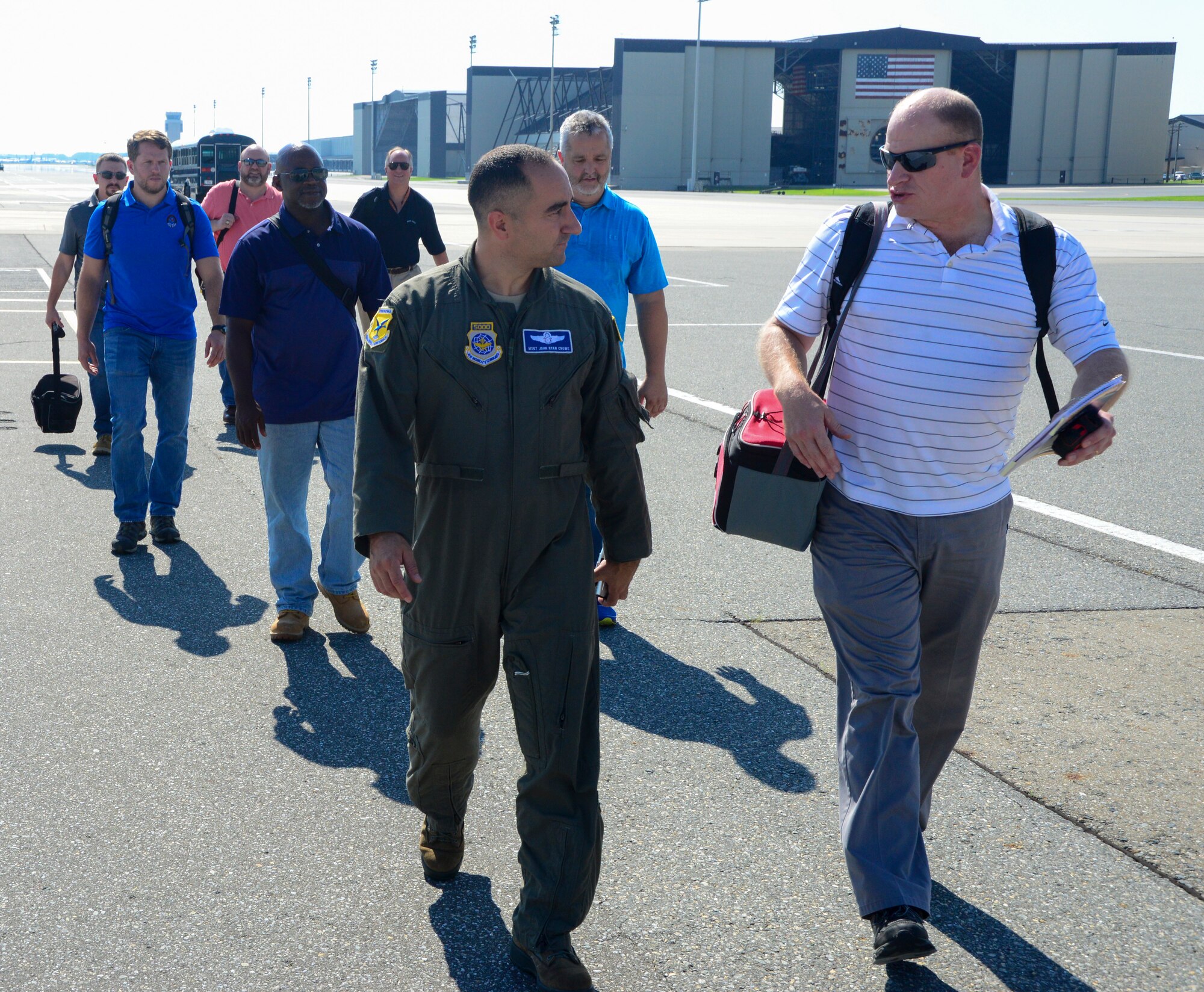 Master Sgt John Crowe, 9th Arilift Squadron loadmaster, leads a group of engineers and logisiticans from Marine Corps Systems Command land system defense to a C-17 Globemaster III aitcraft Sept. 5, 2018 at Dover Air Force Base, Del. The engineers and logisticians are tasked with finding more equipment that makes the US Marine Corps more leathal.(U.S. Air Force photo by Airman First Class Jonathan Harding)
