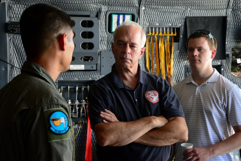 A loadmaster speaks with two members from Marine Corps Systems Command land systems defense acquisition team Sept 5. 2018, at Dover Air Force Base. The Marine Corps is constantly looking for ways to move more equipment while constantly decreasing cost (U.S. Air Force photo by Airman First Class Jonathan Harding)