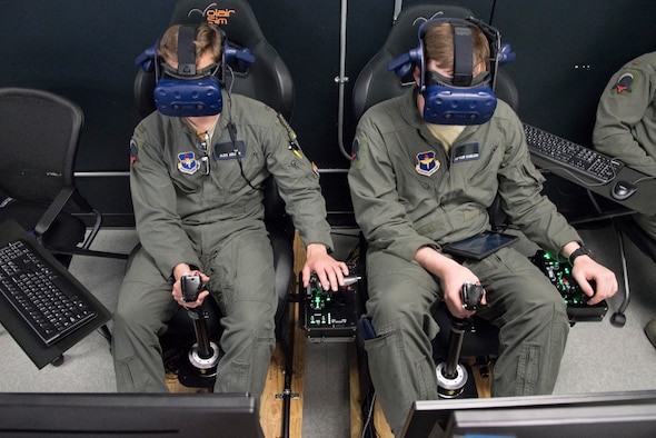 U.S. Air Force Second Lt. Charles Keller and Airman First Class Tyler Haselden, Pilot Training Next students, train on a virtual reality flight simulator at the Armed Forces Reserve Center in Austin, Texas, June 21, 2018. Air Education and Training Command officials announced the second iteration of Pilot Training Next would begin in January 2019 during a panel at the 2018 Air Force Association Air, Space and Cyber Conference in National Harbor, Maryland. (U.S. Air Force photo by Sean M. Worrell)