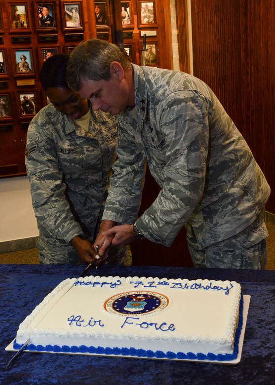Two people cutting a cake.