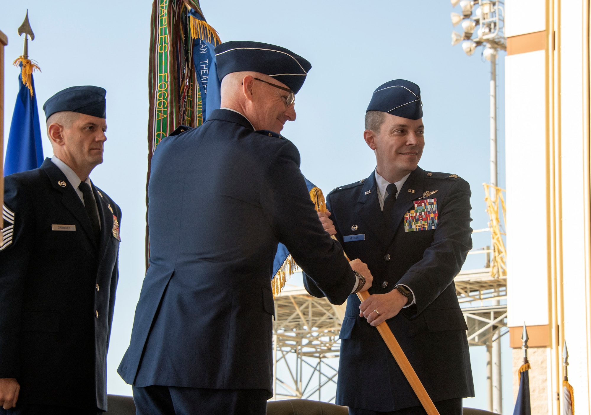 Maj. Gen. Sam Barrett, 18th Air Force commander, passes the 60th Air Mobility Wing guidon to Col. Jeff Nelson, 60th Air Mobility Wing commander, during an assumption of command ceremony at Travis Air Force Base, Calif., Sept. 18, 2018. During the ceremony, Nelson assumed command of Air Mobility Command’s largest wing. (U.S. Air Force photo by Lan Kim)