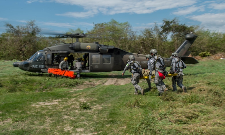 Airmen from the Colombian Air Force load triage patients onto a Colombian UH-60 Blackhawk during a mass casualty earthquake simulation as part of the multilateral exercise Angel de los Andes Sept. 6, 2018, at German Olano Air Base, Colombia. The simulation focused on aeromedical evacuation and casualty evacuation operations. (U.S. Air Force photo by Staff Sgt. Robert Hicks)