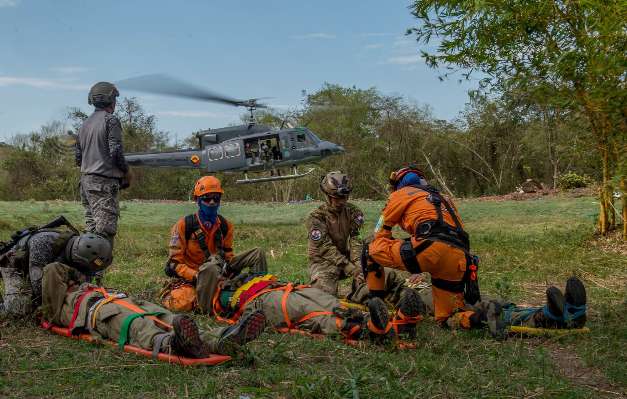 Triage patients wait to be air evacuated on a Colombian Bell 212 helicopter during a simulation as part of the multilateral exercise Angel de los Andes Sept. 6, 2018 at German Olano Air Base, Colombia. The simulation focused on aeromedical evacuation and casualty evacuation operations. (U.S. Air Force photo by Staff Sgt. Robert Hicks)
