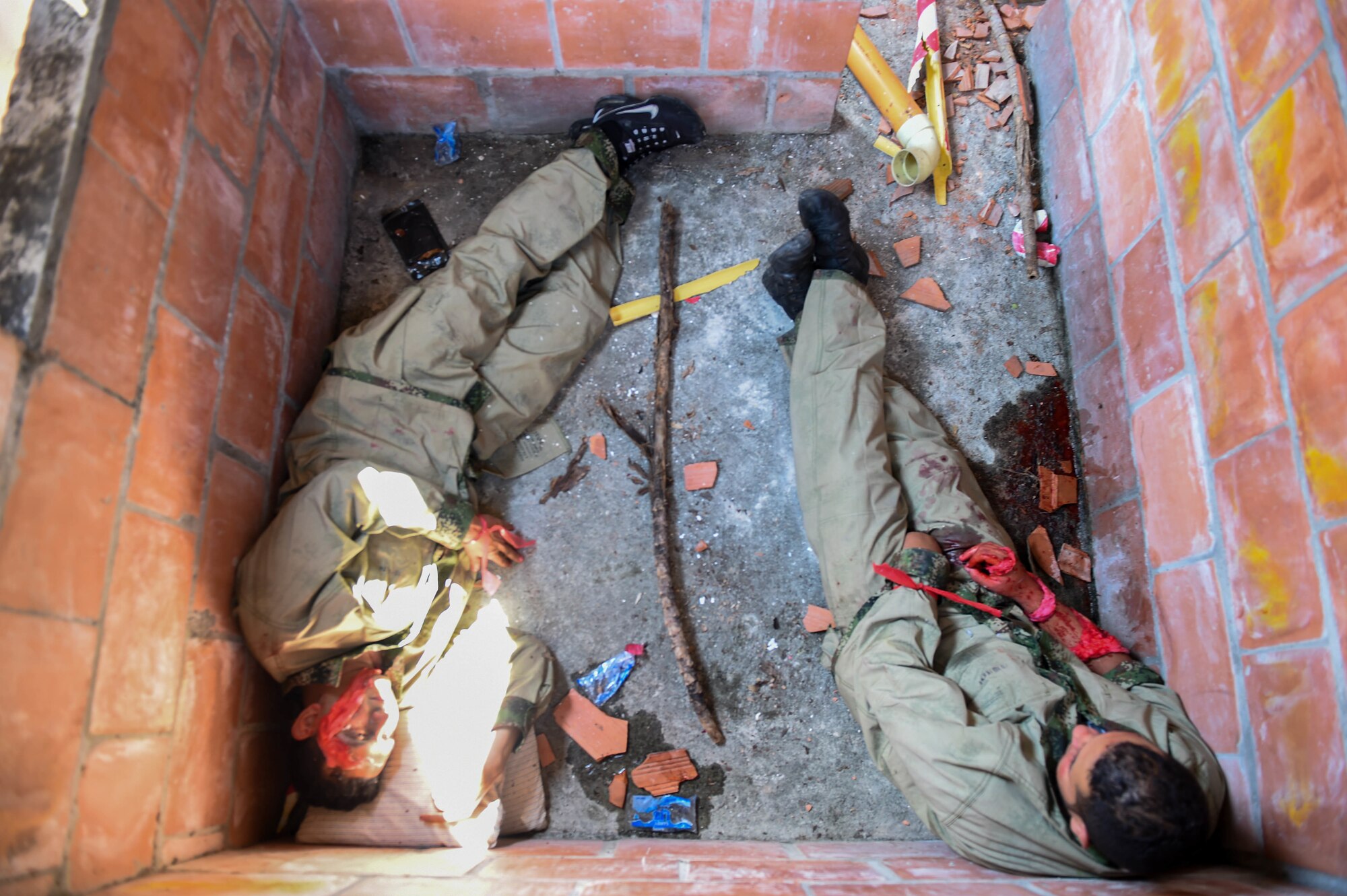Triage patients wait to be rescued during a mass casualty earthquake simulation as part of the multilateral exercise Angel de los Andes Sept. 6, 2018, at German Olano Air Base, Colombia. The first week of the exercise is focused on responding to natural disaster scenarios that include an earthquake response, a forest fire and an open water rescue, as well as responding to an aircraft crash.  (U.S. Air Force photo by Staff Sgt. Robert Hicks)