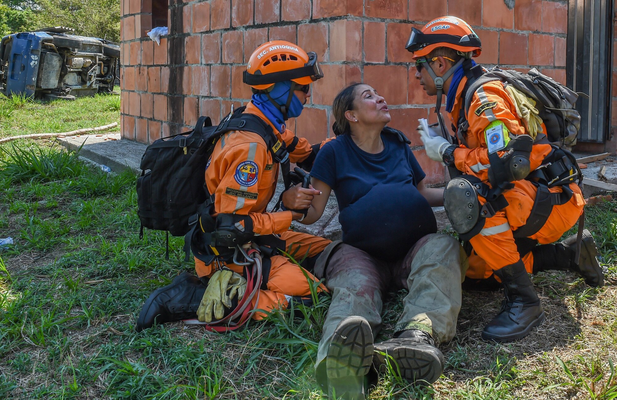 Colombian civil defense members aids a pregnant triage patient during a simulation as part of the multilateral exercise Angel de los Andes Sept. 6, 2018 at German Olano Air Base, Colombia. Angel de los Andes is a search and rescue exercise hosted by Colombia involving 12 partner nations working together in a multi-national environment and focuses on exercising search and rescue, aeromedical evacuation and casualty evacuation operations. (U.S. Air Force photo by Staff Sgt. Robert Hicks)