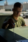 Pfc. Max Hulsey tightens the cover on an environmental control unit (ECU) after an operational test Sept. 17, 2018 at Camp Kinser, Okinawa, Japan. Electronic Maintenance Company (EMC) conducts operational tests to ensure their equipment is running properly. Hulsey, a native of Poulsbo, Washington, is a basic refrigeration and air conditioning technician with EMC, Maintenance Battalion, Combat Logistics Regiment 35. (U.S. Marine Corps photo by Lance Cpl. Jamin M. Powell)