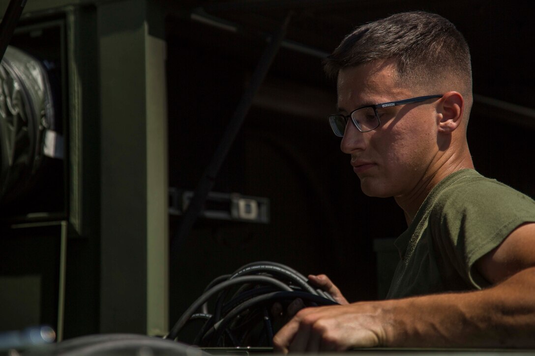 Pfc. Max Hulsey tests the operations of an environmental control unit (ECU) Sept. 17, 2018 at Camp Kinser, Okinawa, Japan. ECUs are serviced in and out of use to ensure they run properly when deployed. Hulsey, a native of Poulsbo, Washington, is a basic refrigeration and air conditioning technician with Electronic Maintenance Company, Maintenance Battalion, Combat Logistics Regiment 35. (U.S. Marine Corps photo by Lance Cpl. Jamin M. Powell)