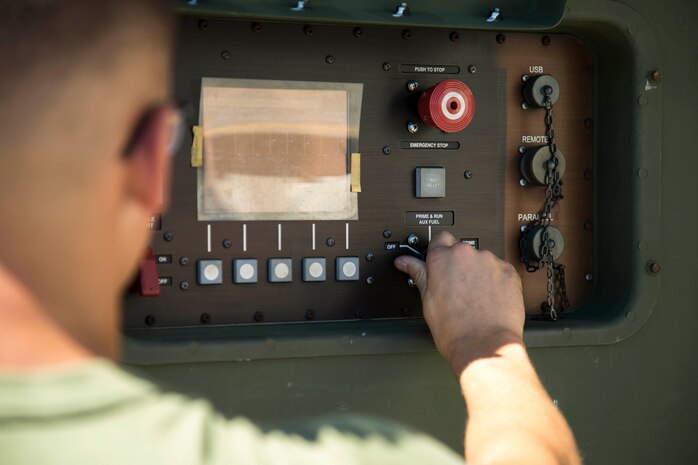 Pfc. Max Hulsey turns on the power of an environmental control unit (ECU) during a preventative operational test Sept. 17, 2018 at Camp Kinser, Okinawa, Japan. Electronic Maintenance Company (EMC) conducts operational tests to ensure their equipment is running properly. Hulsey, a native of Poulsbo, Washington, is a basic refrigeration and air conditioning technician with EMC, Maintenance Battalion, Combat Logistics Regiment 35. (U.S. Marine Corps photo by Lance Cpl. Jamin M. Powell)
