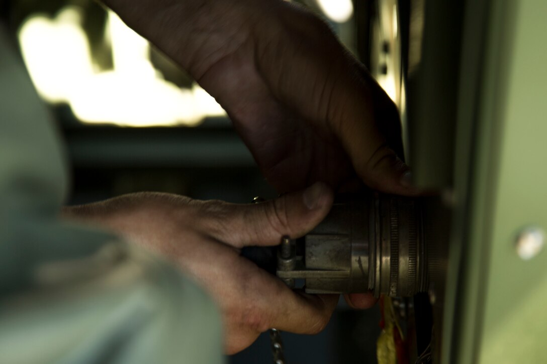 Pfc. Max Hulsey connects a power cord to an environmental control unit (ECU) while doing operational tests Sept. 17, 2018 at Camp Kinser, Okinawa, Japan. Electronic Maintenance Company uses basic refrigeration and air conditioning technicians to ensure their equipment is properly serviced and ready to be deployed. Hulsey, a native of Poulsbo, Washington, is a basic refrigeration and air conditioning technician with EMC, Maintenance Battalion, Combat Logistics Regiment 35. (U.S. Marine Corps photo by Lance Cpl. Jamin M. Powell)