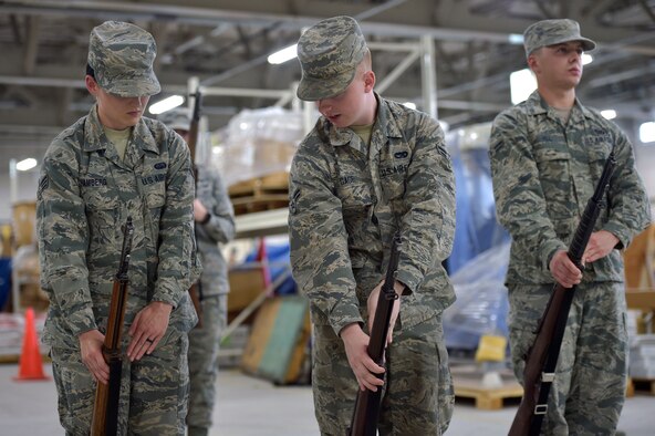 U.S. Air Force Airman 1st Class William Gage, center, a 35th Honor Guard guardsman, teaches Senior Airman Madeline Hamberg, left, a 35th Communications Squadron network operations technician, how to perform a rifle manual at Misawa Air Base, Japan, Sept. 12, 2018.  The training period to be a guardsman is self-paced and usually takes two months to complete. (U.S. Air Force photo by Tech. Sgt. Stephany Johnson)