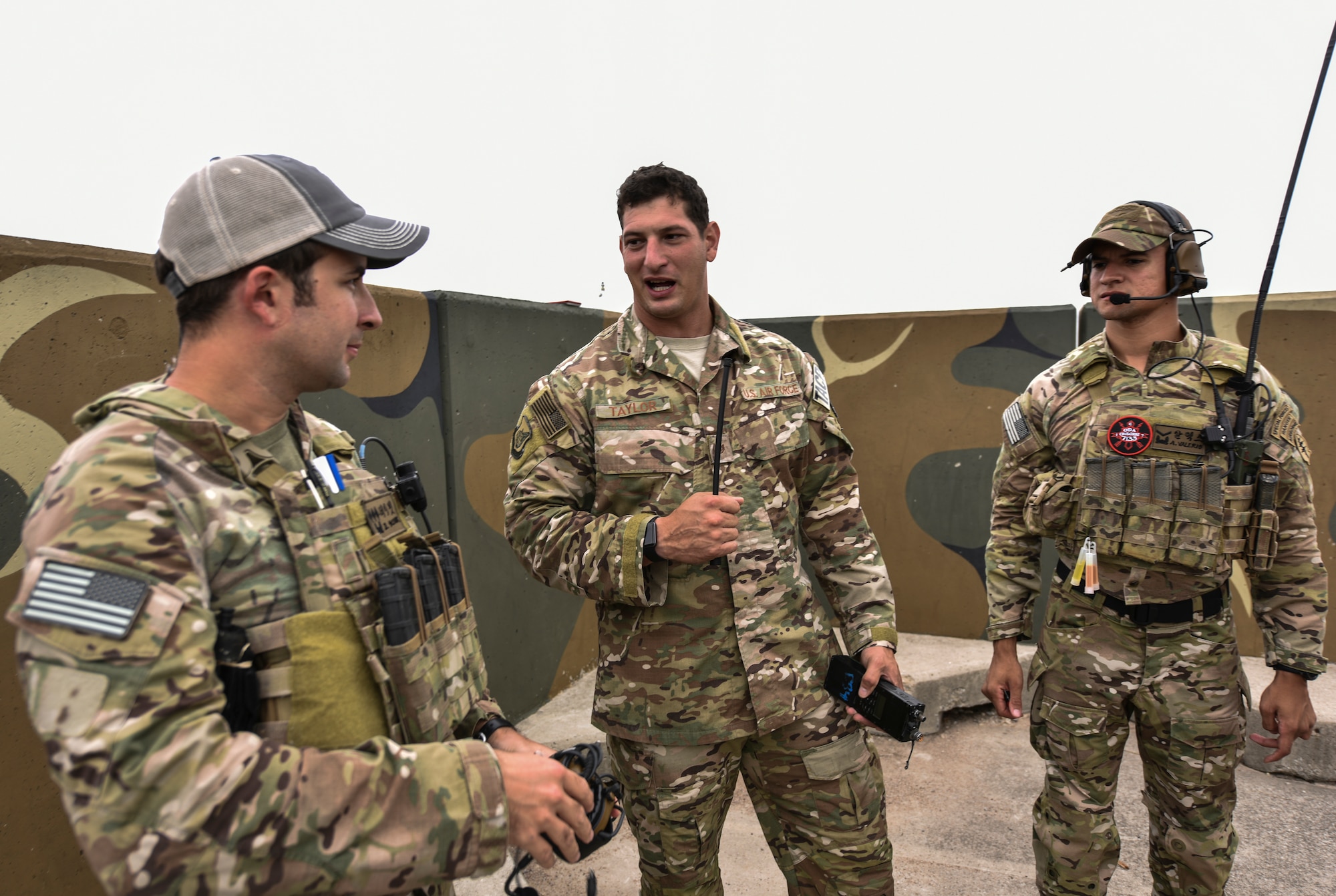 U.S. Air Force Staff Sgt. Thad Taylor, a tactical air control party specialist from the 15th Air Support Operations Squadron, Fort Stewart, Georgia (middle), debriefs two U.S. Army soldiers from the 7th Special Forces Group on their performance after simulated close air support training Sept. 13, 2018 at Kunsan Air Base, Republic of Korea. The two soldiers were tasked with guiding live aircraft to multiple different targets for simulated air strikes. (U.S. Air Force photo by Senior Airman Stefan Alvarez)