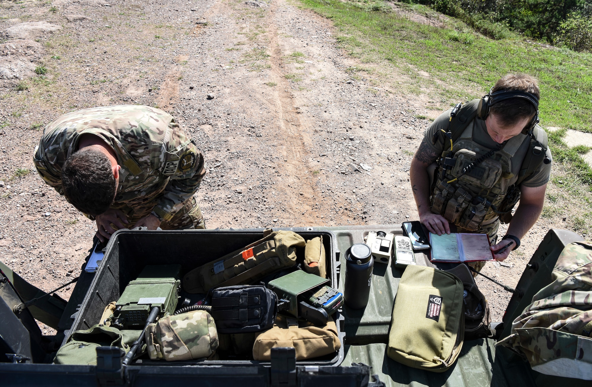 U.S. Air Force Staff Sgt. Thad Taylor (left), a tactical air control party specialist from the 15th Air Support Operations Squadron, Fort Stewart, Georgia, and 1st Lt. Clay West, 15th ASOS air liaison officer, set up a joint terminal attack controller training site Sept. 12, 2018 at Kunsan Air Base, Republic of Korea. The JTAC training objectives included ensuring deconfliction of friendly artillery, helicopters, and other aircraft. (U.S. Air Force photo by Senior Airman Savannah L. Waters)
