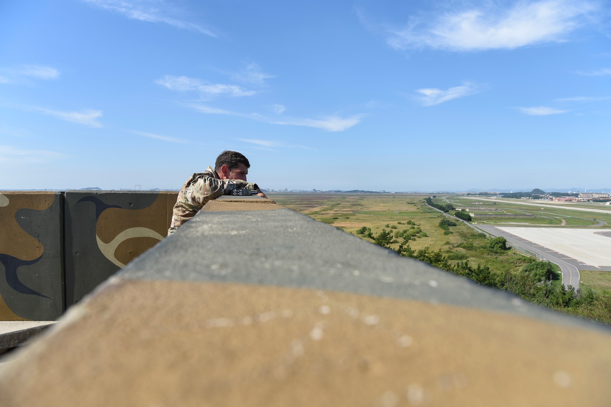 U.S. Air Force Staff Sgt. Thad Taylor, a tactical air control party specialist from the 15th Air Support Operations Squadron, Fort Stewart, Georgia, calls in a target Sept. 12, 2018 at Kunsan Air Base, Republic of Korea. The joint terminal attack controller training integrated real world joint fires observers into a scenario with three-way communication maintained throughout the mission. (U.S. Air Force photo by Senior Airman Savannah L. Waters)