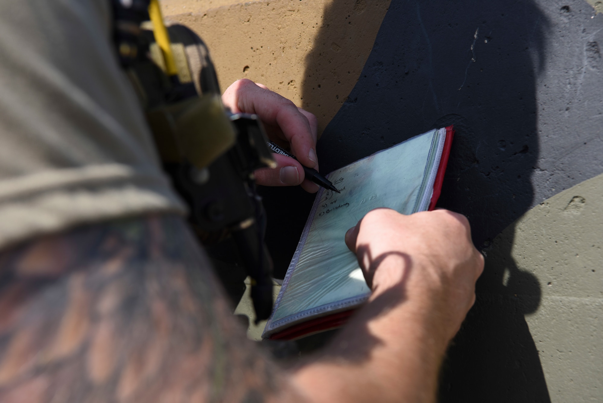U.S. Air Force 1st Lt. Clay West, air liaison officer from the 15th Air Support Operations Squadron, Fort Stewart, Georgia, takes notes on potential targets Sept. 12, 2018 at Kunsan Air Base, Republic of Korea. Joint terminal attack controller training objectives included ensuring deconfliction of friendly artillery, helicopters, and other aircraft. (U.S. Air Force photo by Senior Airman Savannah L. Waters)