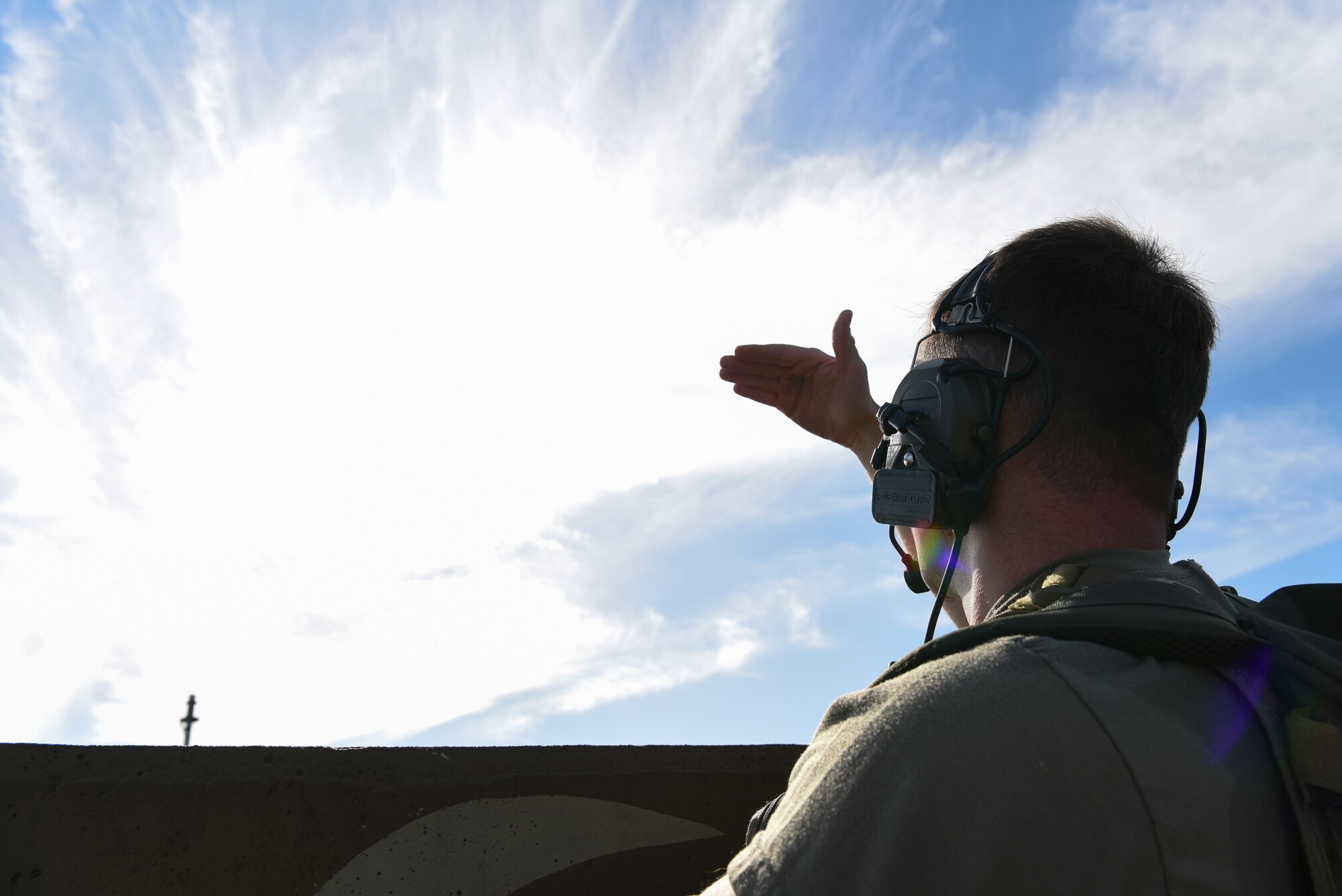 U.S. Air Force 1st Lt. Clay West, air liaison officer from the 15th Air Support Operations Squadron, Fort Stewart, Georgia, looks for a F-16 Fighting Falcon during joint terminal attack controller training Sept. 12, 2018 at Kunsan Air Base, Republic of Korea. The JTAC training integrated real world joint fires observers into a scenario with three-way communication maintained throughout the mission.   (U.S. Air Force photo by Senior Airman Savannah L. Waters)